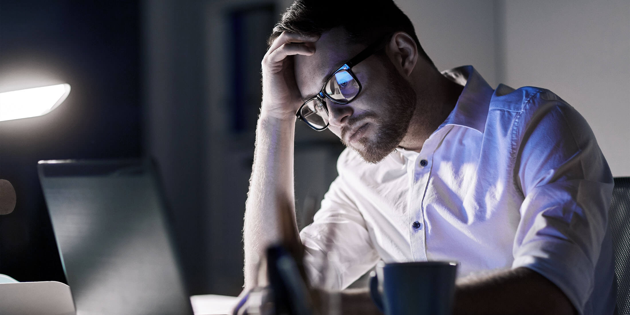 Man thinking at laptop
